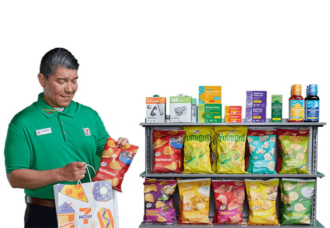 7-Eleven franchise manager putting product from shelf into a shopping bag