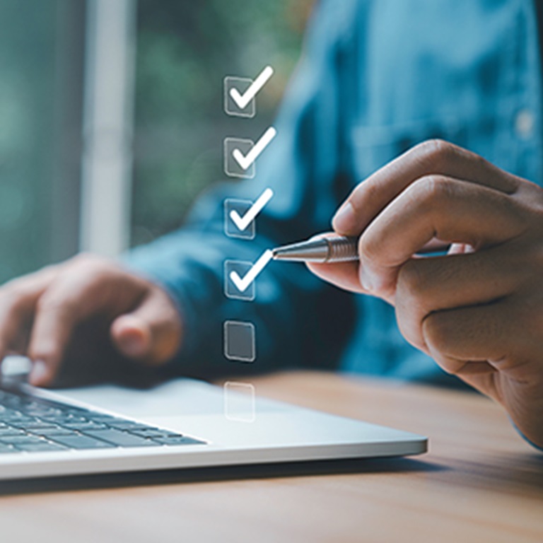 Businessman uses pen to tick digital checkboxes 