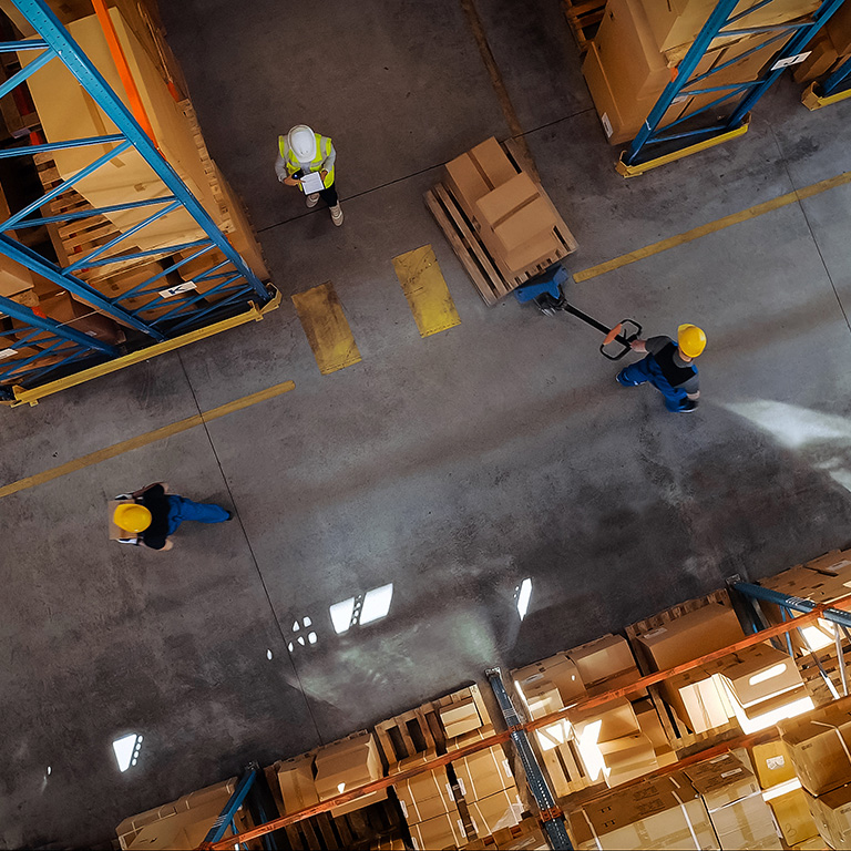 Top-Down View: In Warehouse People Working, Forklift Truck Operator Lifts Pallet with Cardboard Box. Logistics, Distribution Center with Products Ready for Global Shipment, Customer Delivery