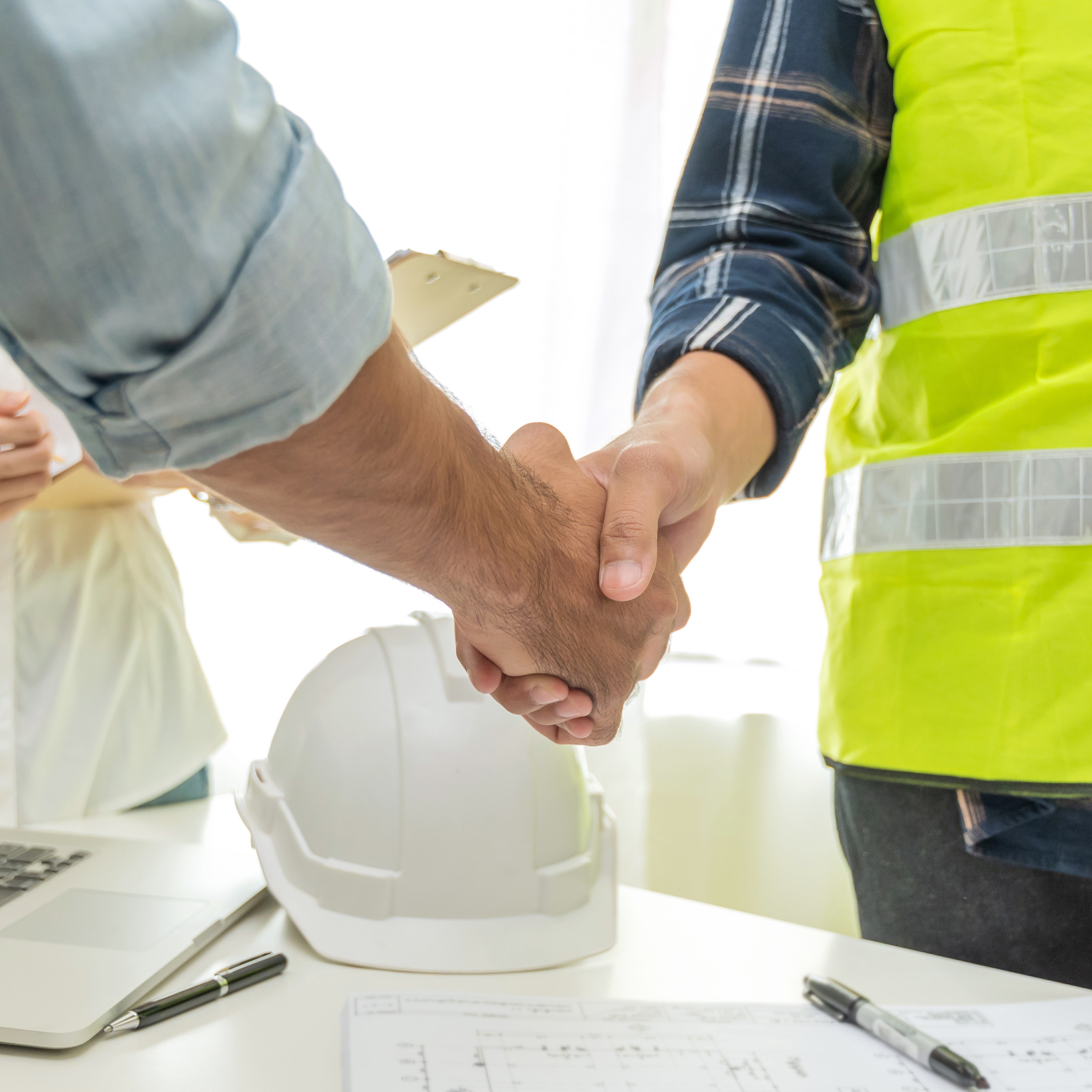 contractor handshake with customer after business meeting start up project contract in construction site office building, business partnership, engineering, cooperate business and teamwork concept