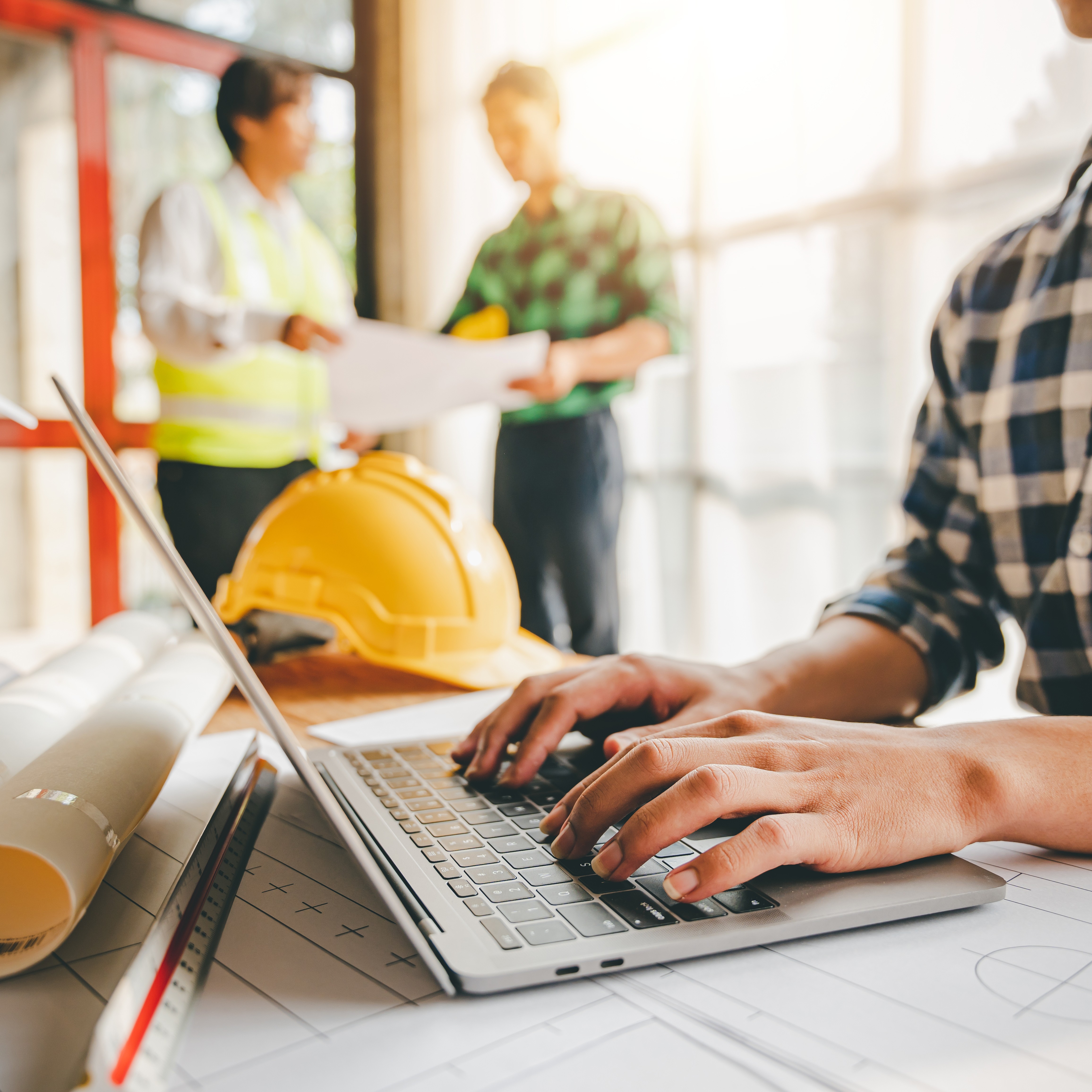 Engineers work as a team with blueprints for architectural plans. Engineer sketching construction project concept with architect equipment Architects talking at table Teamwork and construction concept